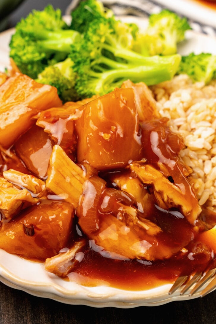 Crock Pot Pineapple Pork Loin cooked low and slow with onions in a rich, savory broth, served with rice and broccoli for an outstanding family dinner.