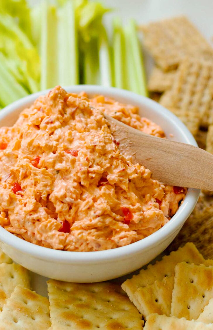 Homemade Pimento Cheese is a classic Southern recipe that's rich, creamy, and so easy to make. This cheesy spread made with pimentos and just the right amount of peppery seasoning is perfect served with crackers and celery as a sandwich or slathered on a burger.