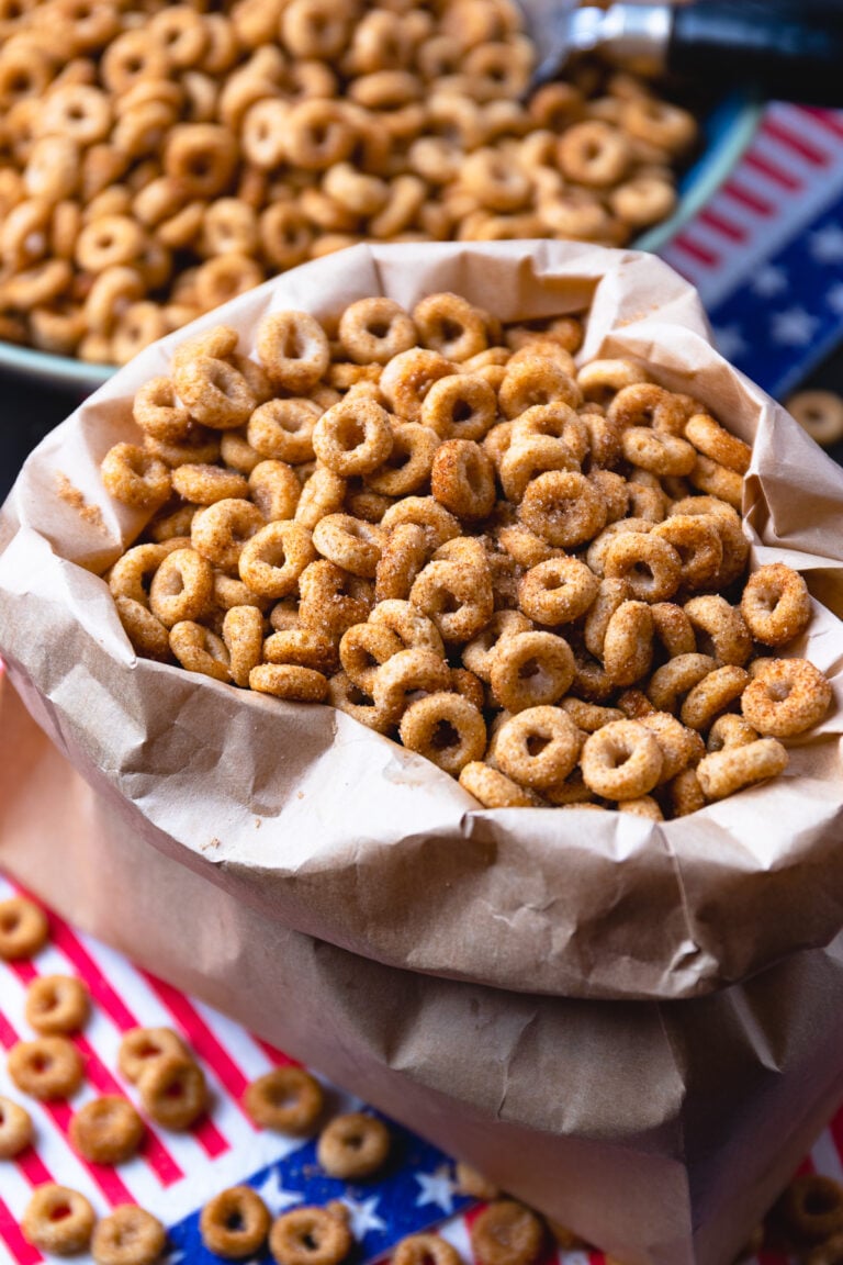 Brown paper bag with fried buttered cheerios tossed in cinnamon sugar.