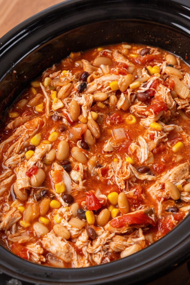 Black crock pot with Taco Soup with beans, corn and white and black beans.