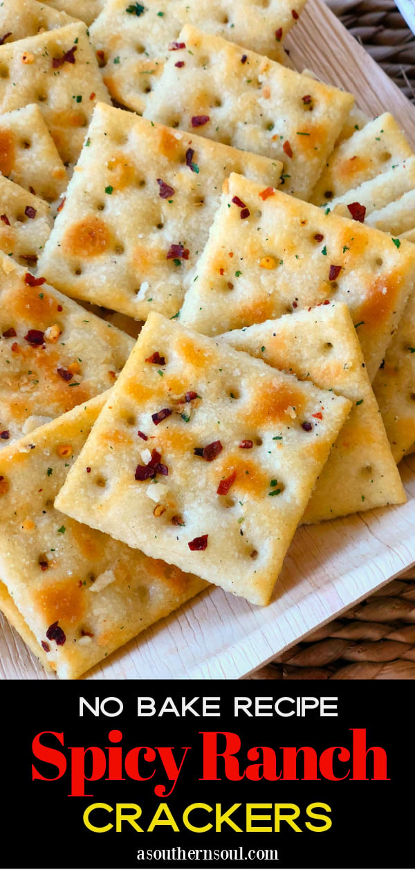 Saltine crackers with red pepper flakes and ranch dressing served on a white plate alongside tomato soup.