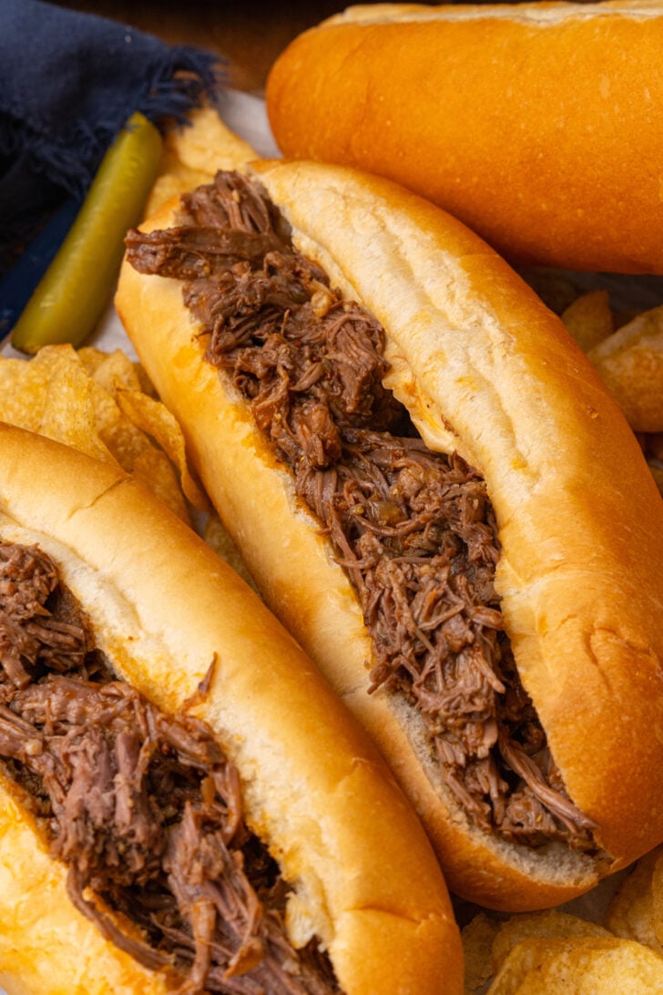 Fresh bread hoagie roll filled with bbq beef cooked in the crock pot served with pickles.
