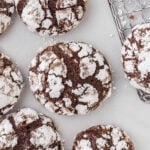 Crinkle cookies sitting on a table near a wire rack.