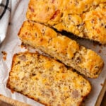 Sausage cheese bread cut into slices on top of a cutting board.
