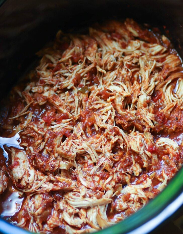 Crock pot with shredded salsa chicken.