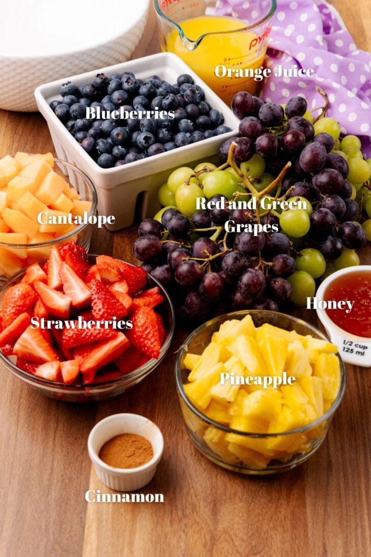 Orange juice, blueberries, green and red grapes, cantalope, strawberries, honey, pineapple and cinnamon for fruit salad.