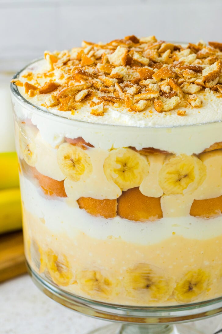 lard bowl with banana pudding. m multiple layers of frosting cookie crumbles and banana.