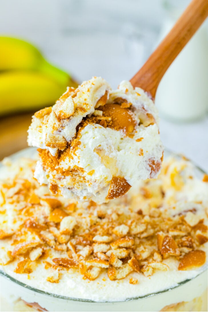 wooden spoon holding a scoop of banana pudding.