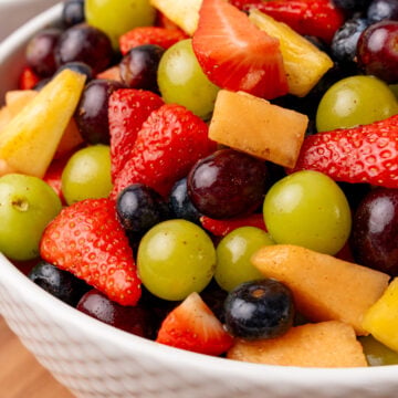 White serving bowl with fresh fruit salad.