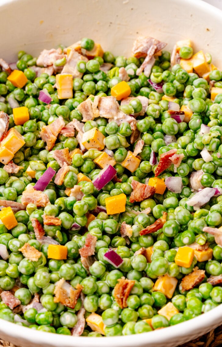 Green peas with cooked bacon, cubed cheddar cheese, and chopped red onion mixed with a creamy dressing.