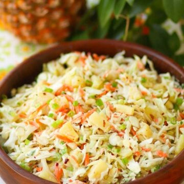 Pineapple Slaw is made with pineapple chunks, bagged cabbage, sliced almonds and green onions with a light, sweet dressing is a side dish that is great for any occasion!