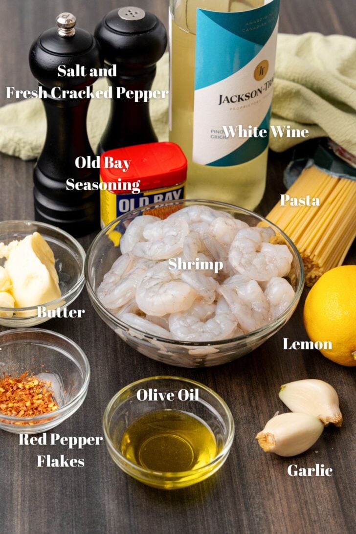 Shrimp, wine, salt, pepper, old bay seasoning, butter, pasta, lemon, garlic, olive oil and red pepper for a shrimp scampi recipe.