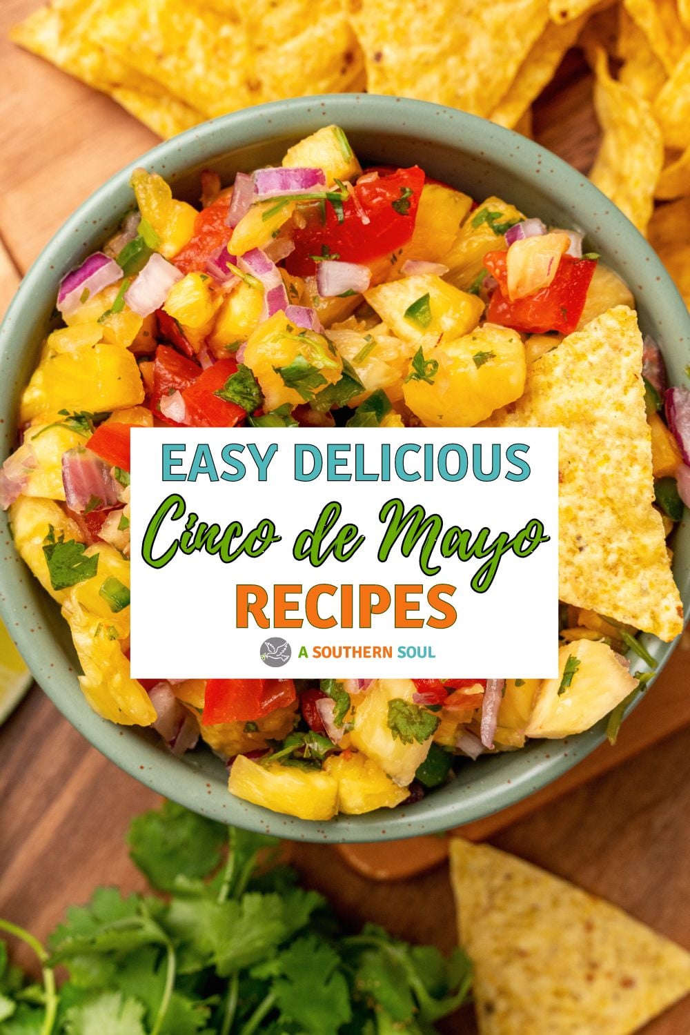Overhead view of corn salsa in gray bowl with red peppers, onions, cilantro, and tortilla chips for Cinco de Mayo 2024 recipes Pinterest pin
