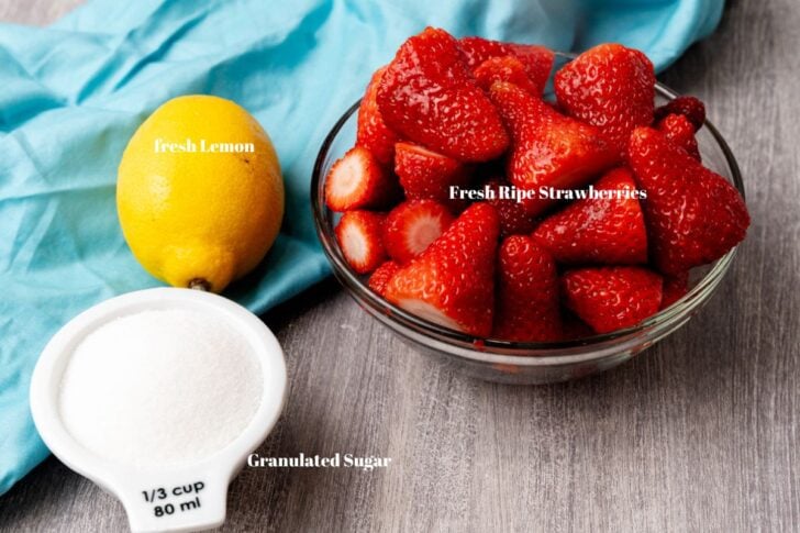 Fresh strawberries, lemon and sugar for strawberry jam.