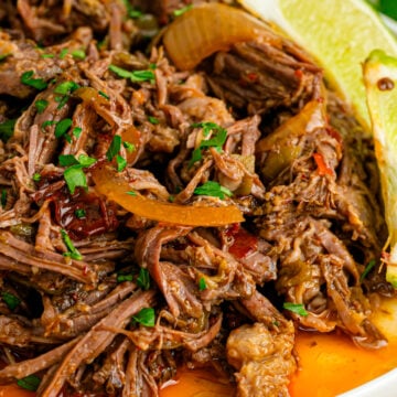 Crock Pot Shredded Mexican Beef served with limes is easy to make and great for so many dishes!