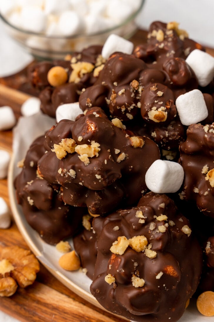 Close up picture of rock road candy clusters. Chocolate covers the entire piece with marshmallows sitting on top.