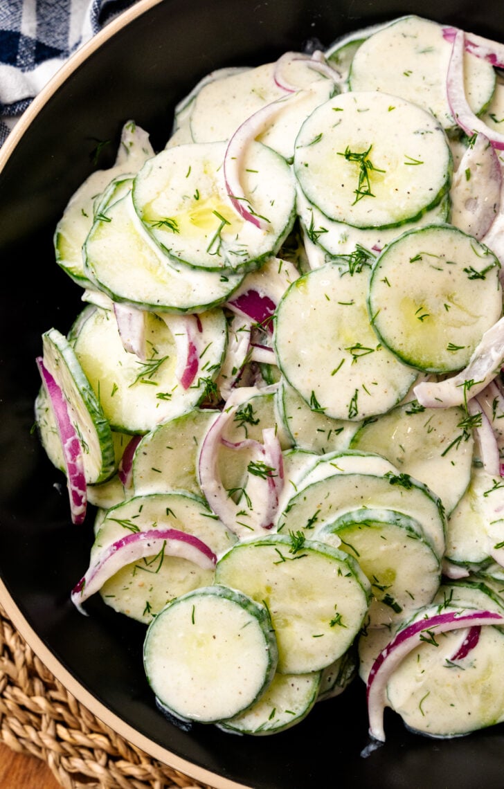 Creamy Cucumber Salad is a cool, refreshing side dish that can be made in minutes! Fresh veggies and dill tossed in a light dressing make this salad perfect for any summer party, weeknight meal, or backyard BBQ.