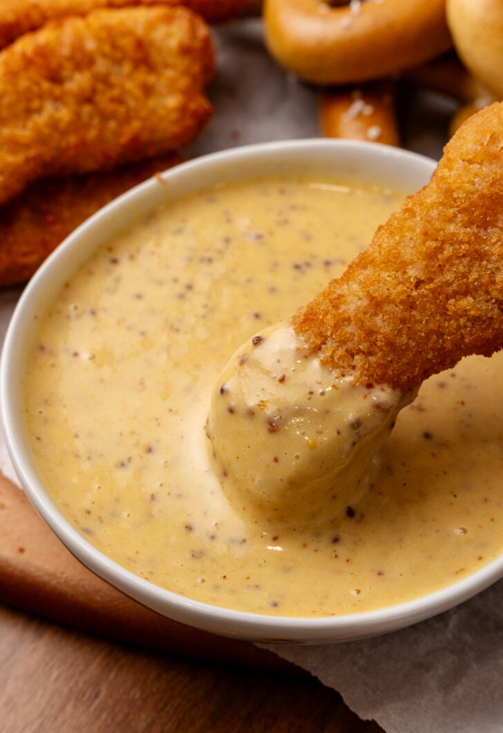 Chicken nugget dipped in honey mustard.