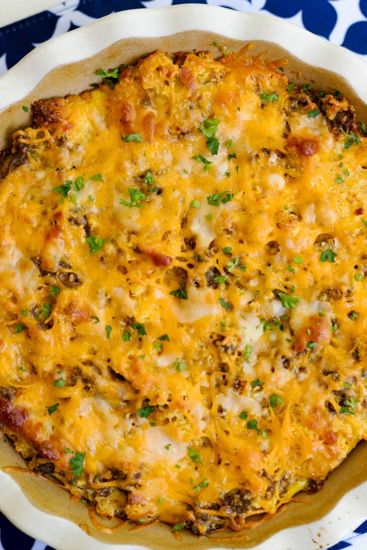 Quiche sitting in a pie dish, the cheese is perfectly melted and combines the sausage and eggs together.