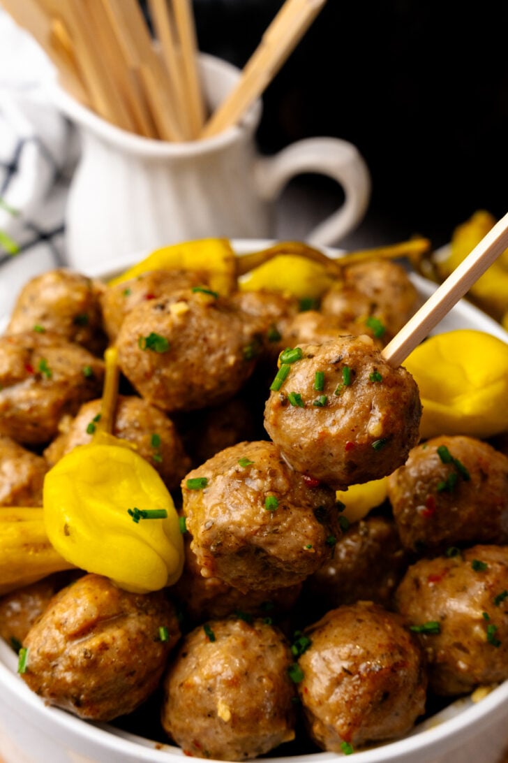 Mississippi Meatballs on a skewers with a yellow pepper next to it.