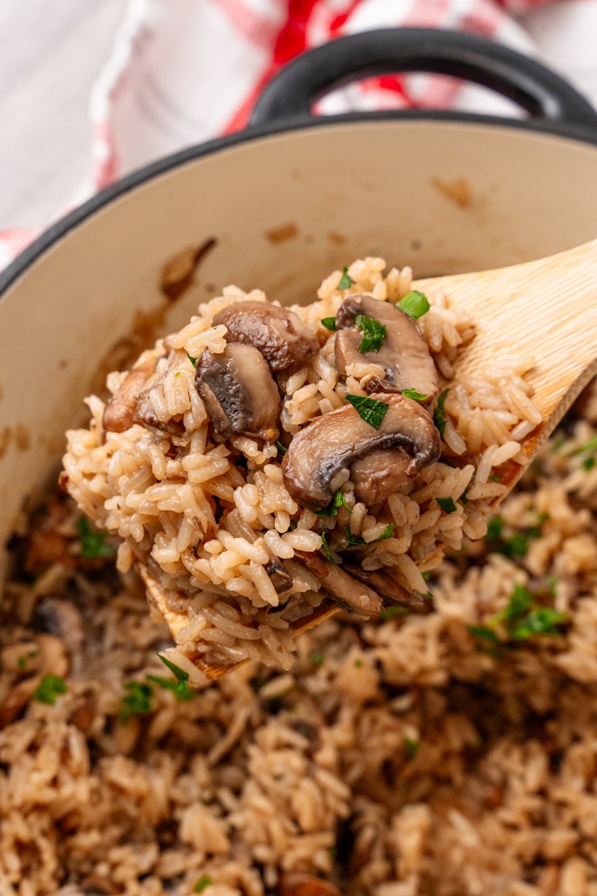 Creamy mushroom rice casserole served in a bowl with a spoon
