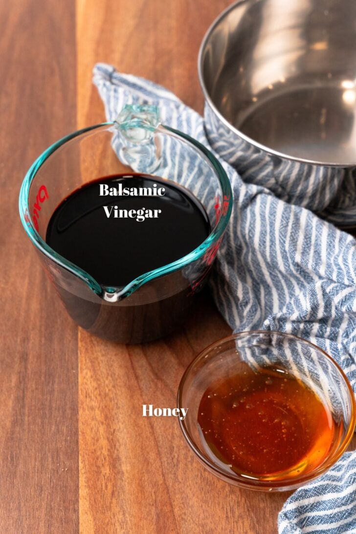 Balsamic vinegar and honey in glass containers.