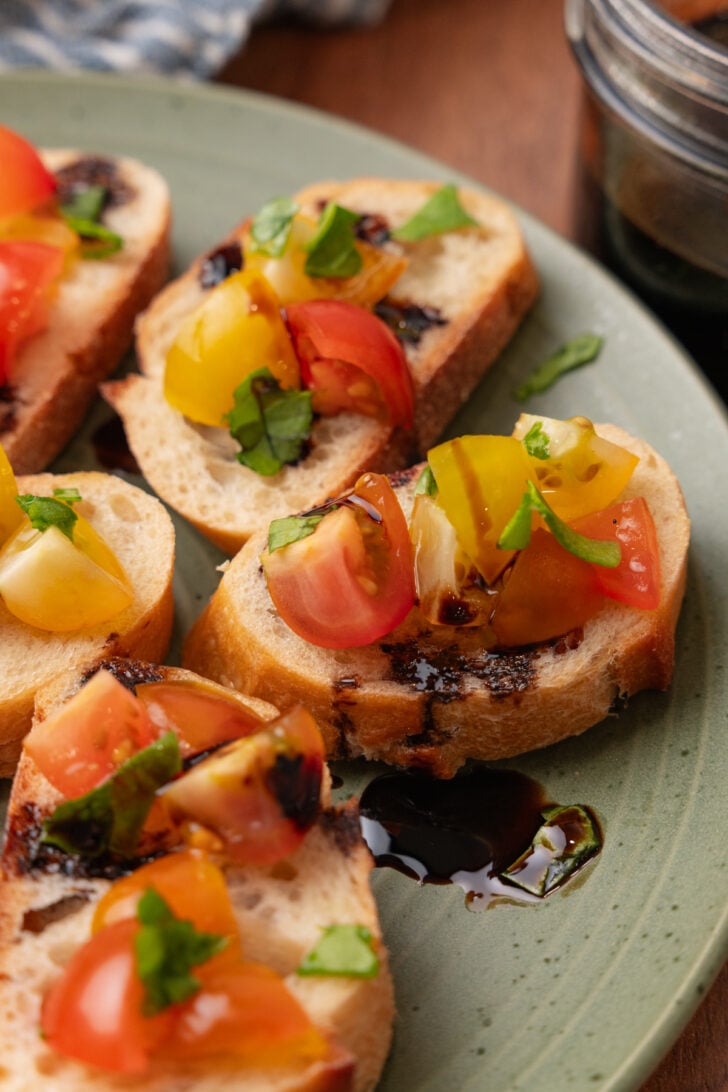 Toast with chopped tomatoes and basil drizzled with balsamic reduction.