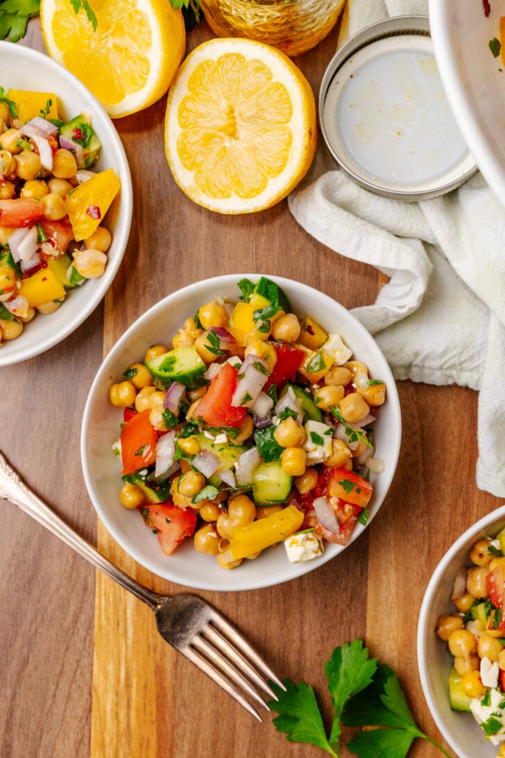 Three white salad bowls filled with Chickpea Salad