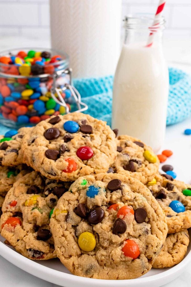 Monster Cookies on a white plate served with cold milk.