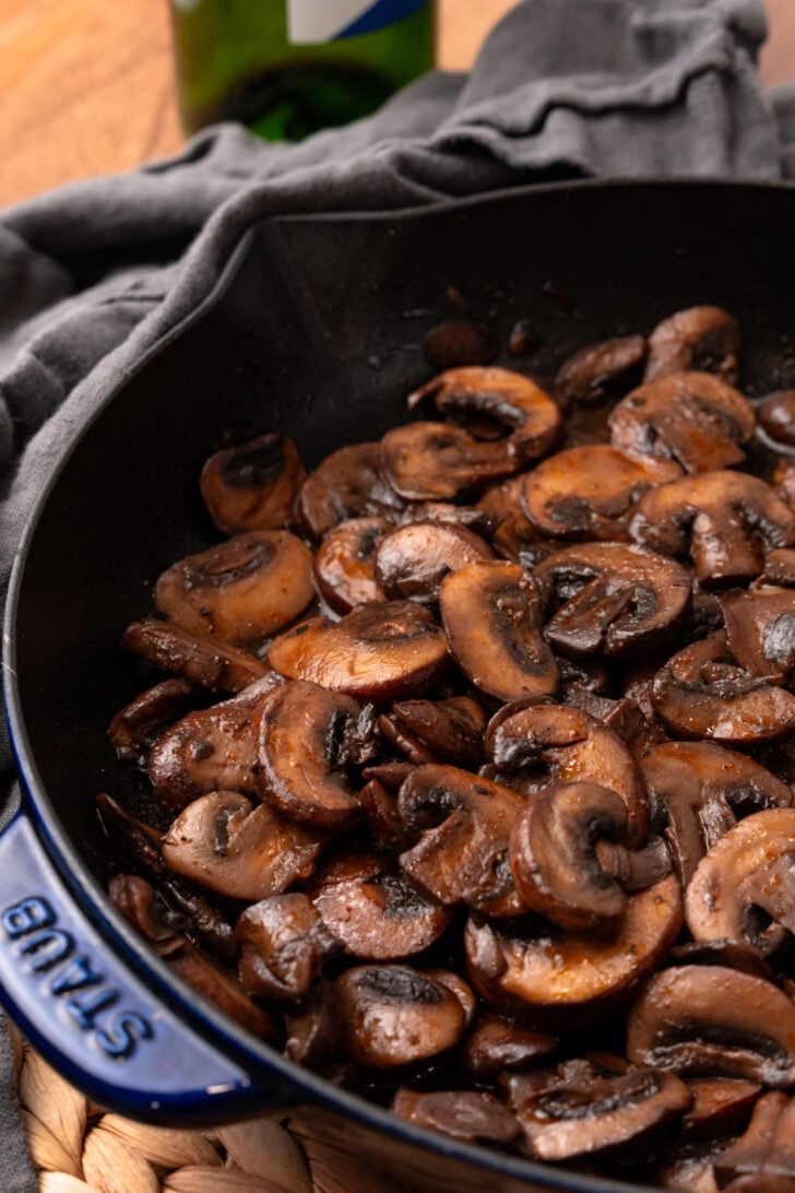 Cooled perfectly sauteed mushrooms in a cast iron skillet.