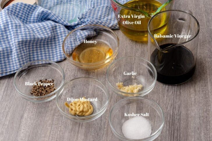 Ingredients for homemade balsamic vinaigrette dressing in clear glass bowls and containers.