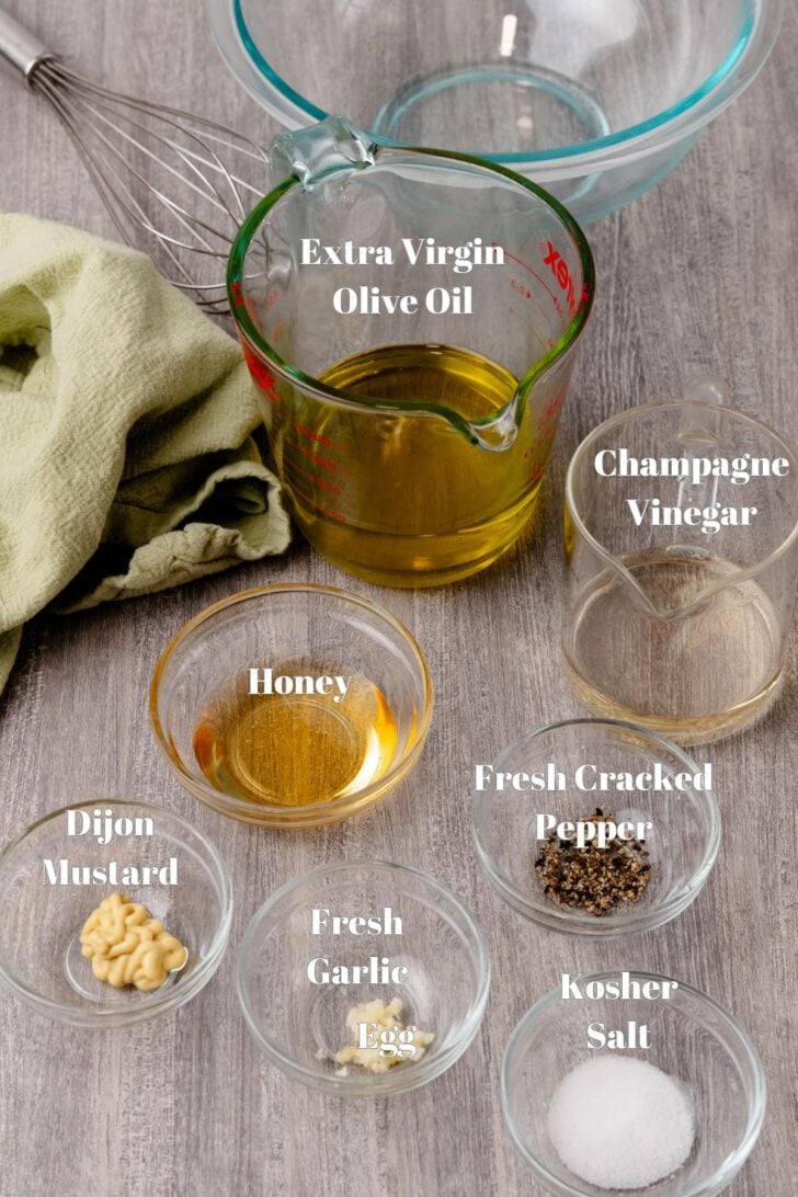 Ingredients for homemade vinaigrett dressing in glass containers.