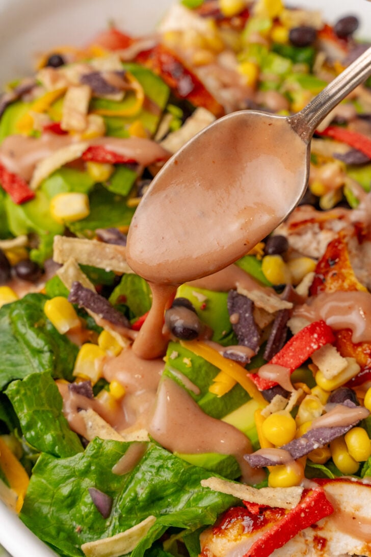 Dressing poured over bbq chicken salad.