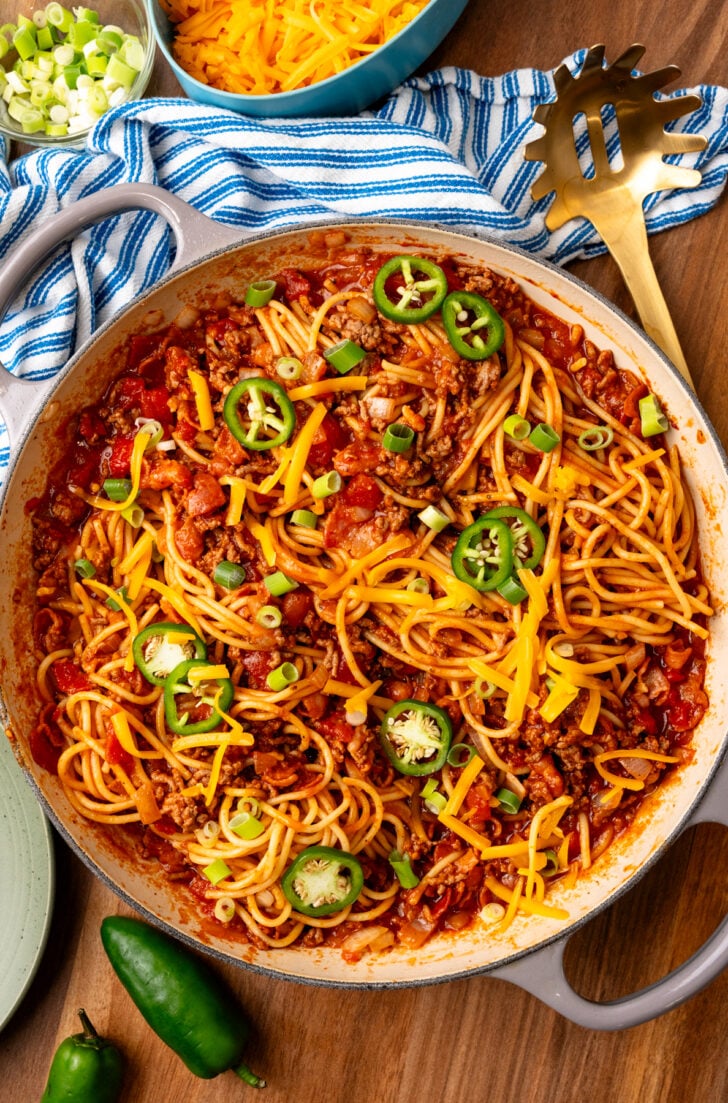 Cowboy Spaghetti is a fun and delicious recipe that combines two classic comfort foods: spaghetti with meat sauce and chili! It's packed with crispy bacon and tossed in a southwestern-style sauce for an irresistible bite. It's perfect for game day, casual entertaining with friends, or a family dinner.