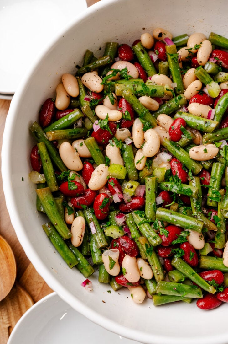 Three Bean Salad combines fresh green beans, creamy red and white beans with a tangy vinaigrette, for a perfect quick and heathy side dish! The vibrant flavors and crunchy texture make it a favorite at potlucks, family parties or as a light lunch. Plus, it's packed with protein and fiber, making it as nutritious as it is tasty.