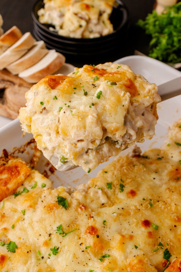 Slice of White ravoil casserole served with a spatula.