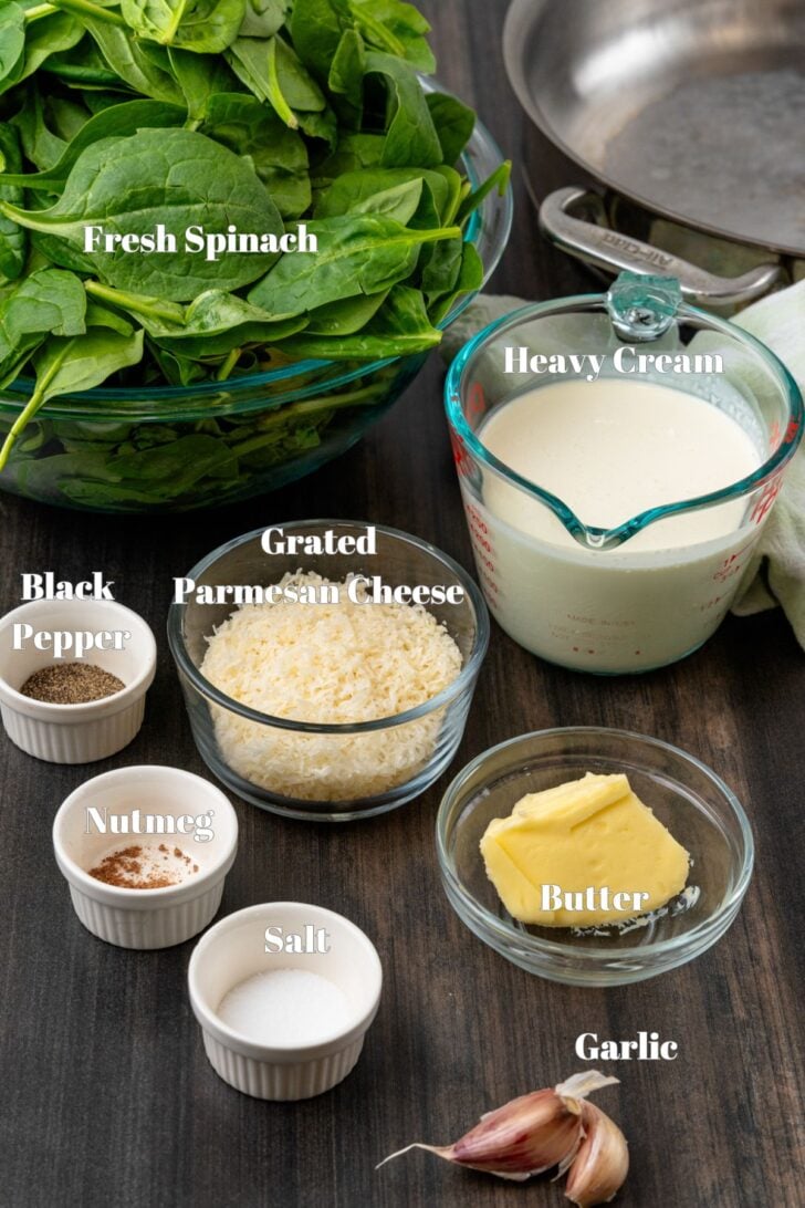 Fresh spinach with other ingredients in glass containers for creamed spinach recipe.