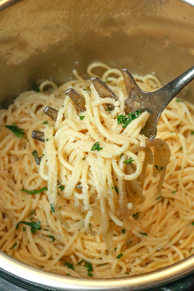 Fork lifting creamy pasta with anchovies and parsley from pot, Quick Fall Pantry Meals for Busy Weeknights