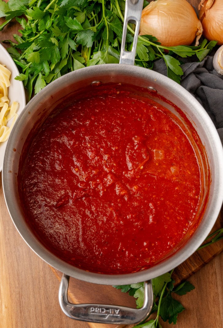 Homemade marinara sauce cooked in a metal sauce pan.