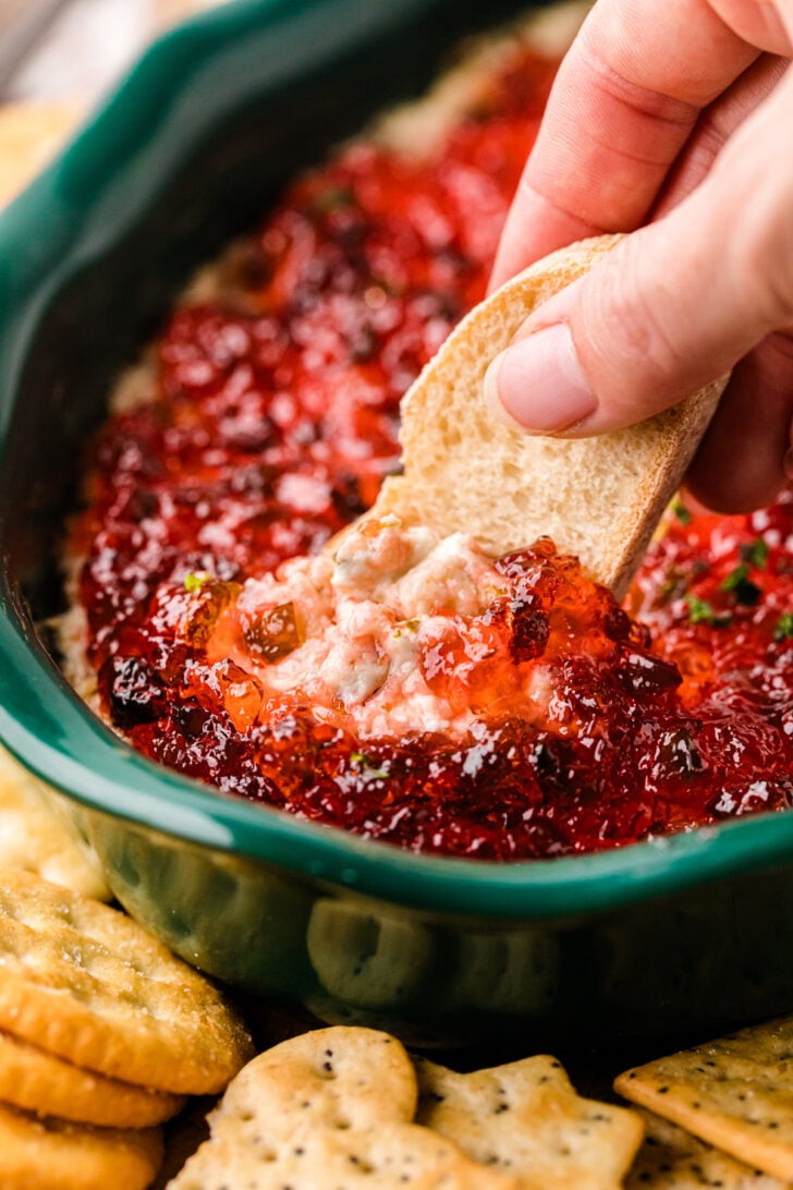 Warm, creamy, savory, and sweet, this Pepper Jelly Cheese Dip With Bacon is the dish everyone will be dipping into! This flavorful spread only takes a few minutes to put together, making it great for a cozy night in, a party, or the holidays. It's the perfect blend of spicy and salty, making for an irresistible bite.