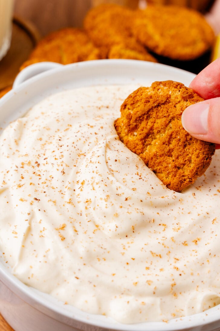 Gingersnap cookie dipped into homemade eggnog dip.