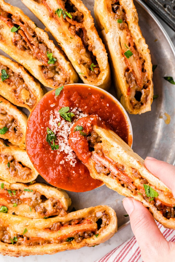 Stromboli from oven Slice of baked stromboli dipped in warm marinara.