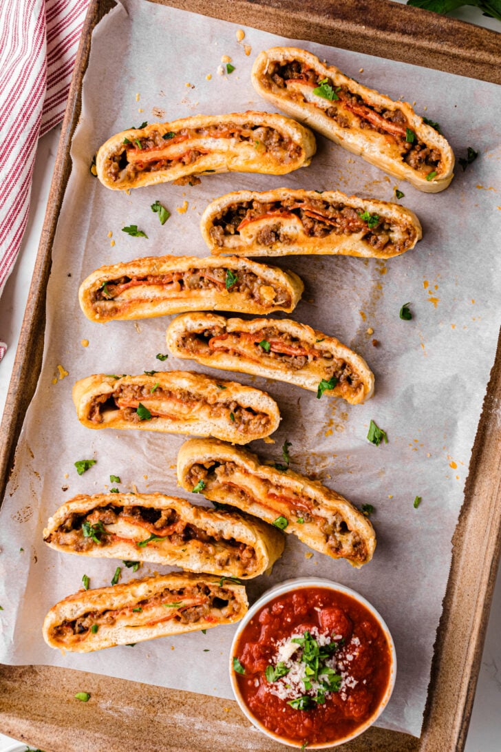 Baked stromboli sliced and served with homemade marinara.