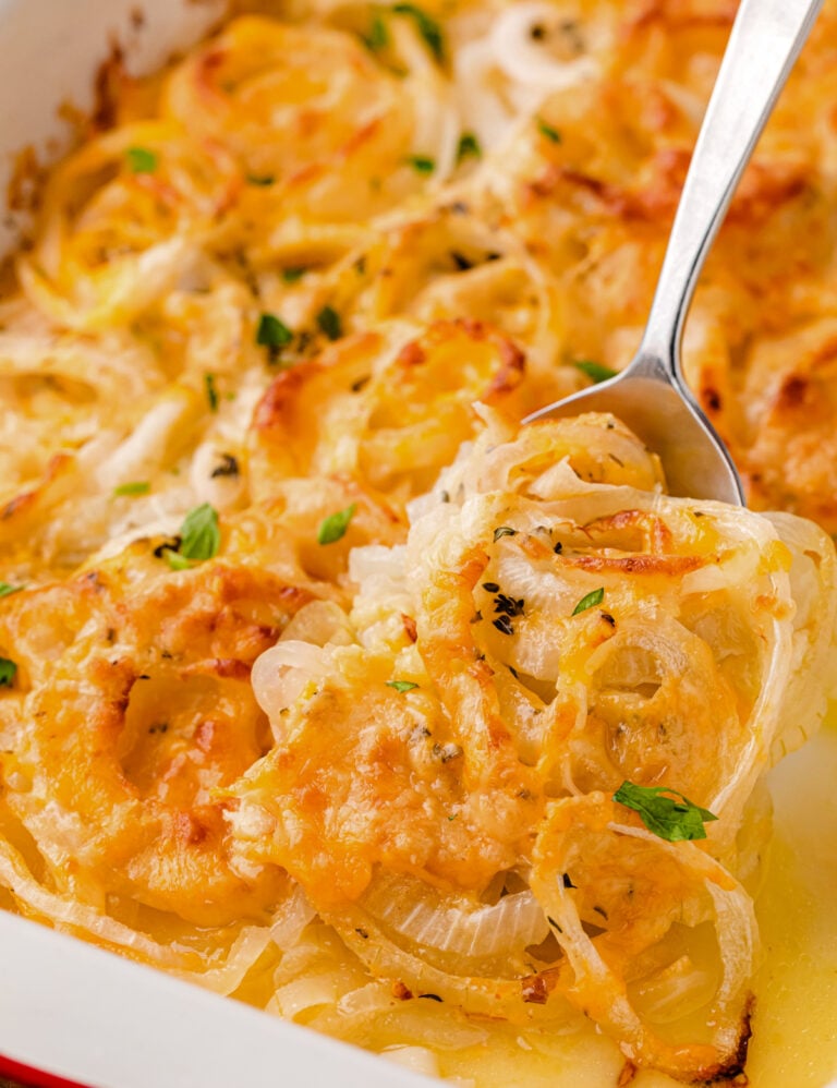 Baked Tennessee Onions: A Southern Classic Side Dish with caramelized onions and melted cheese in a white baking dish, garnished with green