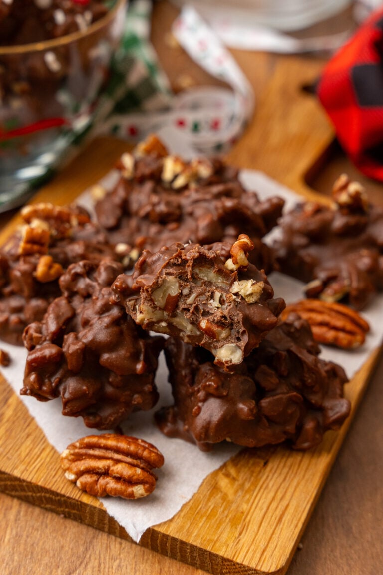 Chocolate pecan clusters with candied pecans on parchment paper, wooden board, holiday setting - Easy Comfort: Recipes Made for Relaxed Summ