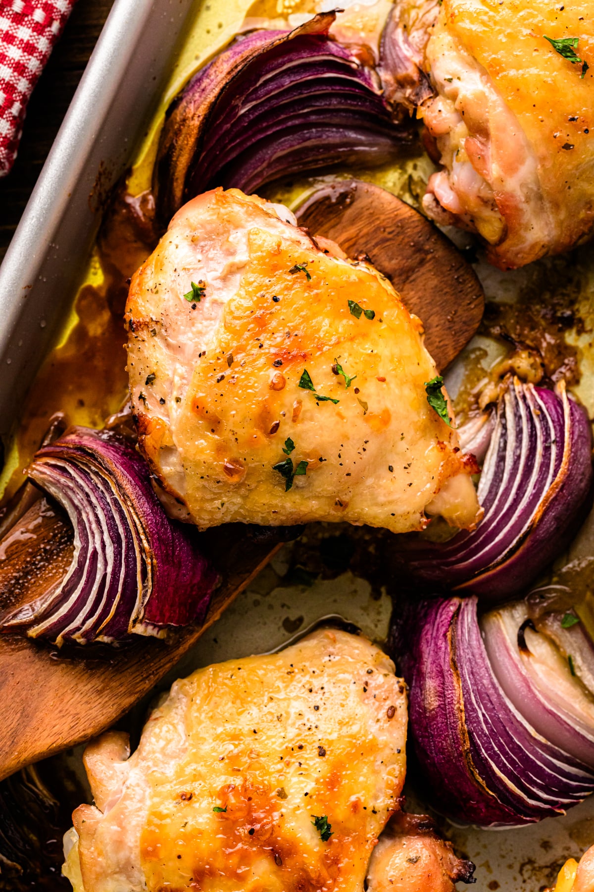 Baked Ranch Chicken – Sheet Pan Recipe with golden chicken breasts and purple onion wedges on a sheet pan, garnished with black pepper and f