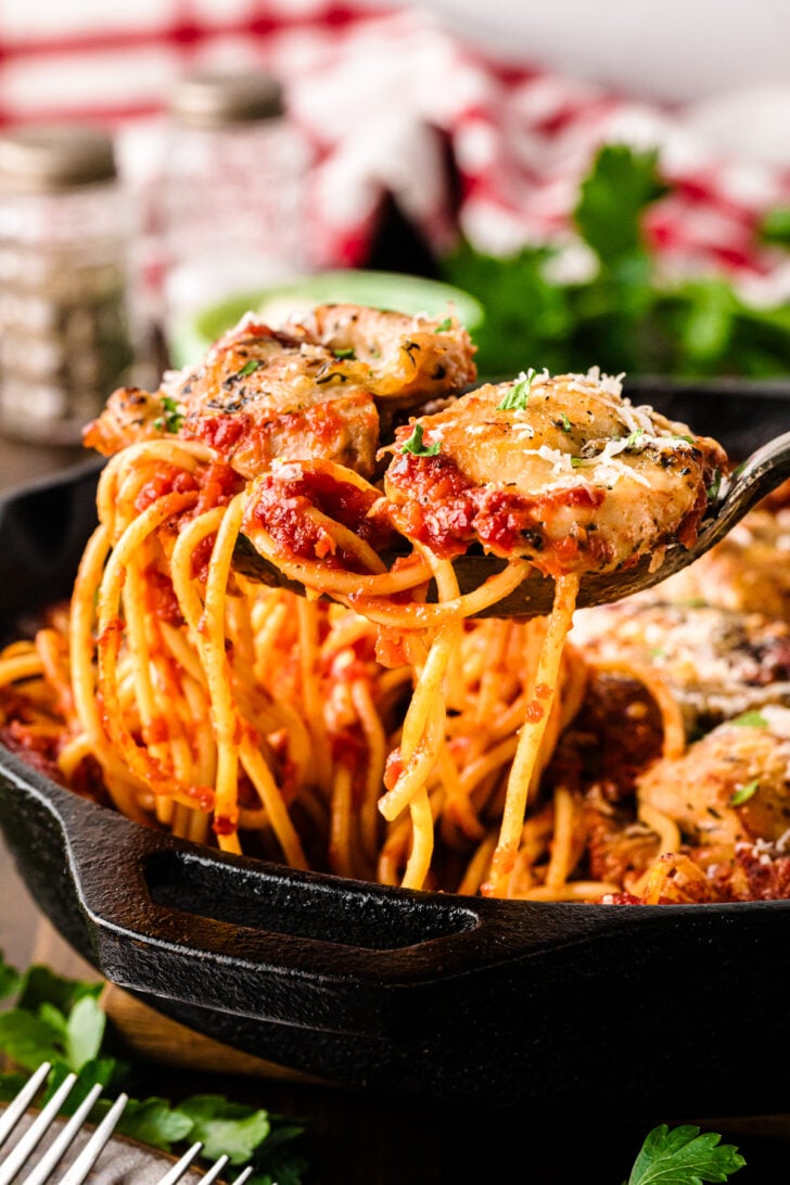 Forkful of skillet chicken spaghetti showing saucy spaghetti and tender chicken coated in tomato sauce, highlighting the texture and bite of this easy weeknight pasta.