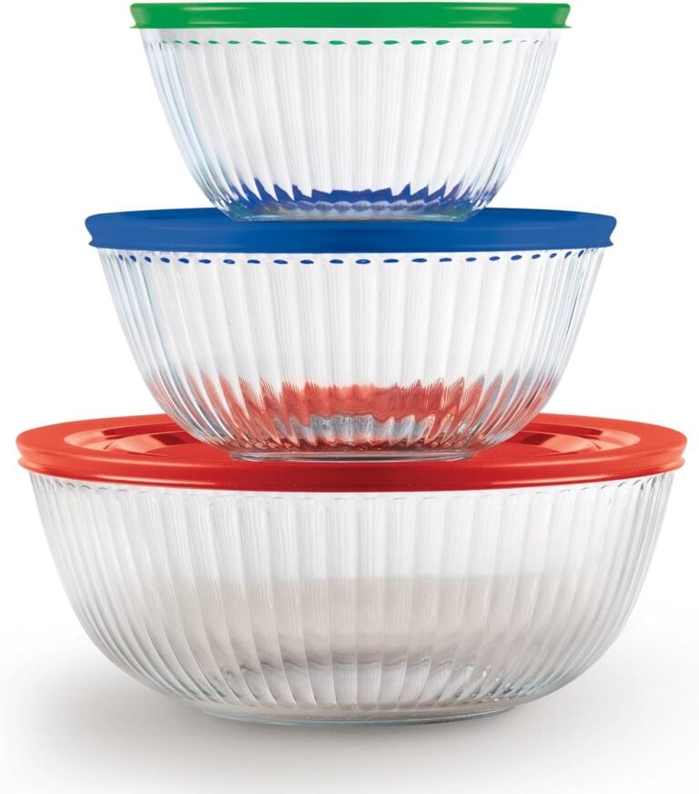 Three clear glass mixing bowls with green, blue, and red plastic lids stacked together, showing ribbed texture design for kitchen storage