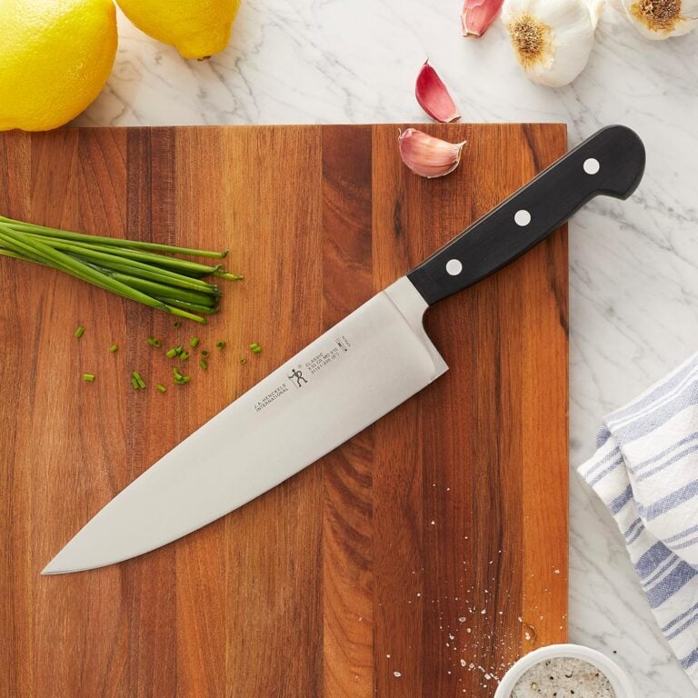 Chef's knife on wooden cutting board with fresh lemons, garlic, green onions, and herbs for My Favorite Sheet Pan Recipes: Easy Dinners with