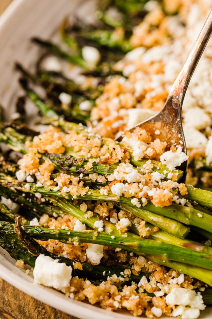 Roasted asparagus with lemon panko and feta on a serving platter, easy spring side dish.